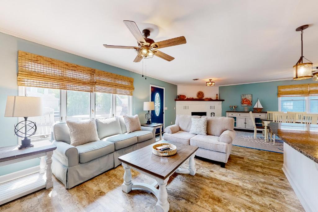 a living room with two couches and a table at Smooth Sailing 14105 in Ocean City