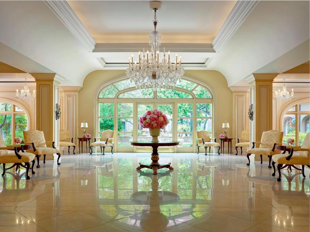 a large room with a table and chairs and a chandelier at The Langham Huntington, Pasadena in Pasadena