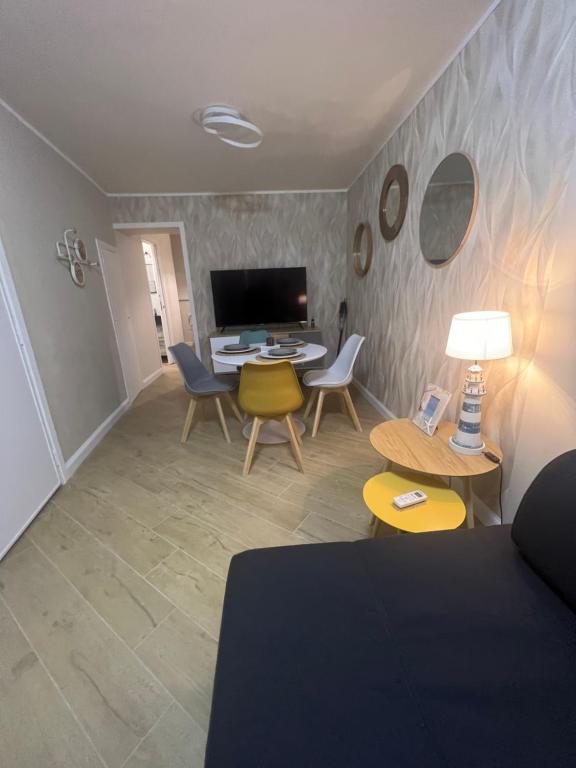 a living room with a couch and a table and chairs at ESSE boutique homes in Cefalù