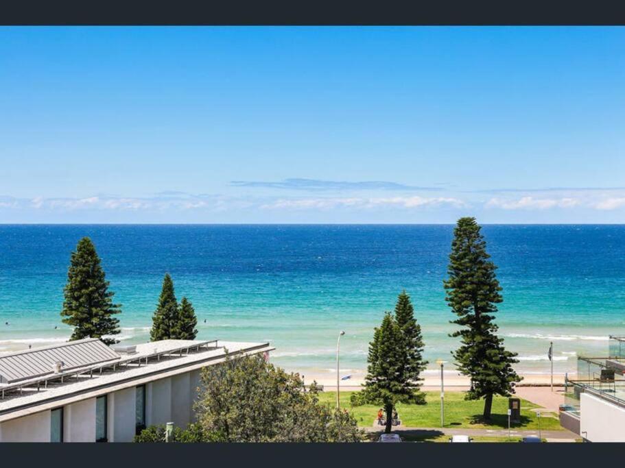 a view of the beach and the ocean from a building at SeaDreams Beachfront Manly in Manly 