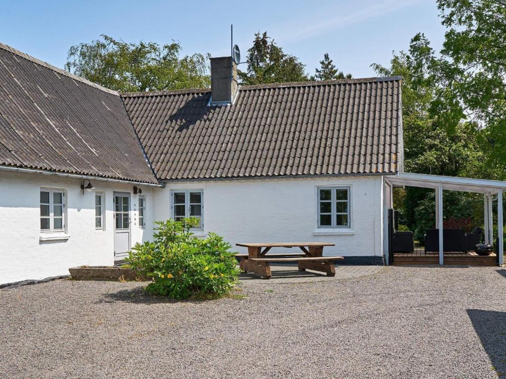ein weißes Gebäude mit einem Picknicktisch davor in der Unterkunft Holiday home Rønne VI in Rønne