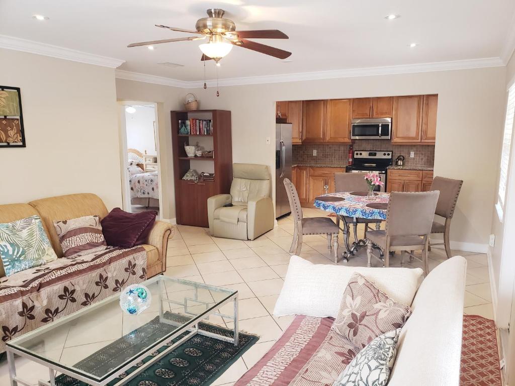 a living room with a couch and a table at OCEAN VACATION BREEZE in Lantana