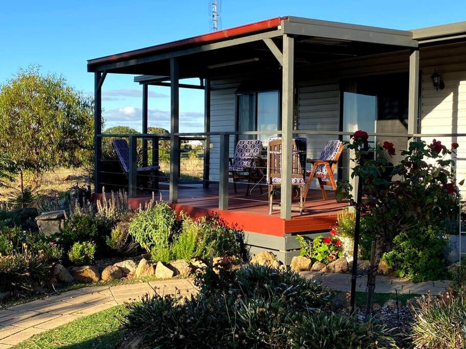 a house with a deck with chairs on it at Bonnie Views Cottage in Clunes