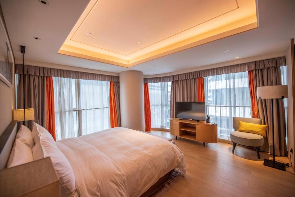 Postel nebo postele na pokoji v ubytování HongQiao Primus Residence Apartment - National Exhibition Center