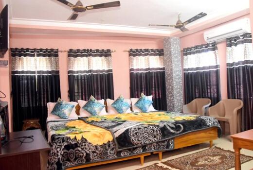 een slaapkamer met een groot bed met blauwe kussens bij HOTEL ROYALE in Calcutta