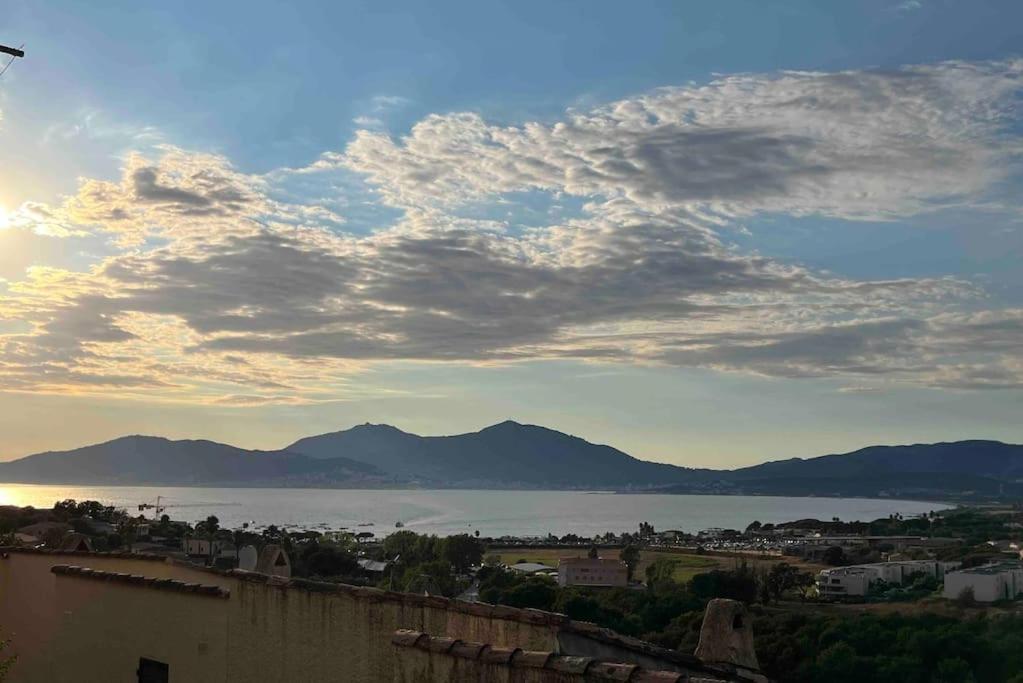 a view of a lake and mountains with a cloudy sky at Charmant 2 pièces avec vue sur mer à Porticcio en Corse du Sud in Porticcio