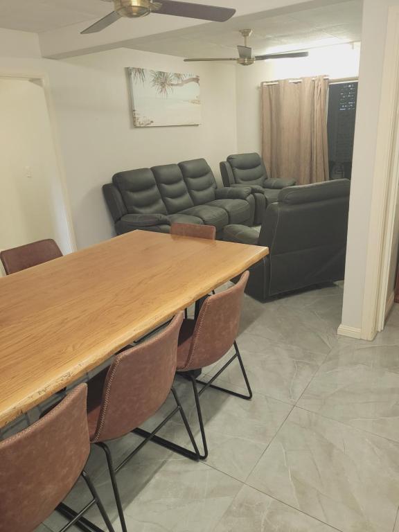a living room with a table and a couch at Paradise Holiday Apartments in Cairns