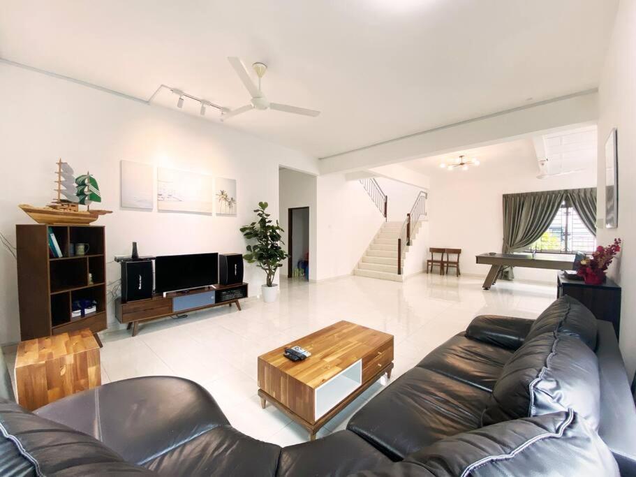 a living room with a leather couch and a coffee table at Nestle Homestay@Batu Pahat in Batu Pahat