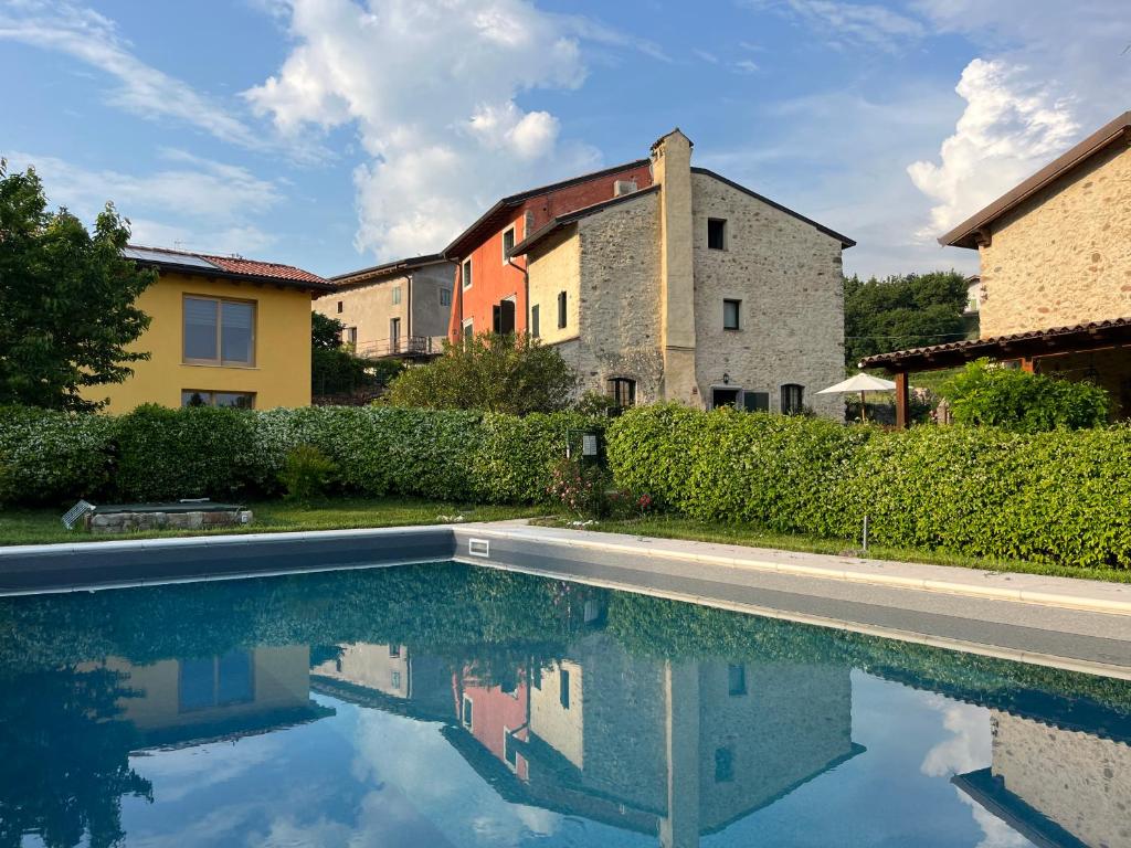 a swimming pool in the yard of a house at Agriturismo Val in Costermano