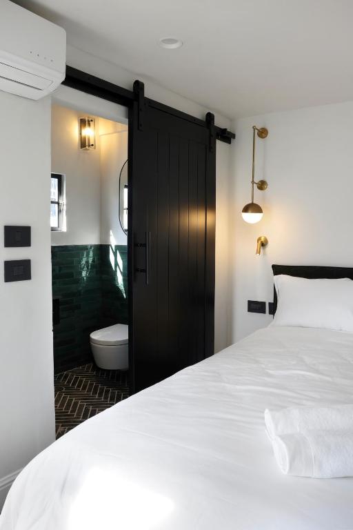 Postel nebo postele na pokoji v ubytování Allegro Neve Tzedek Boutique Suites - By HOMY
