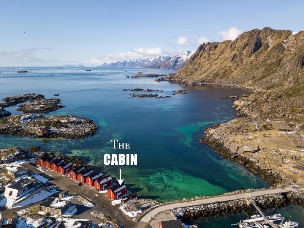 an aerial view of the ocean with mountains in the background at Lofoten Waterfront luxury lodge in Ballstad