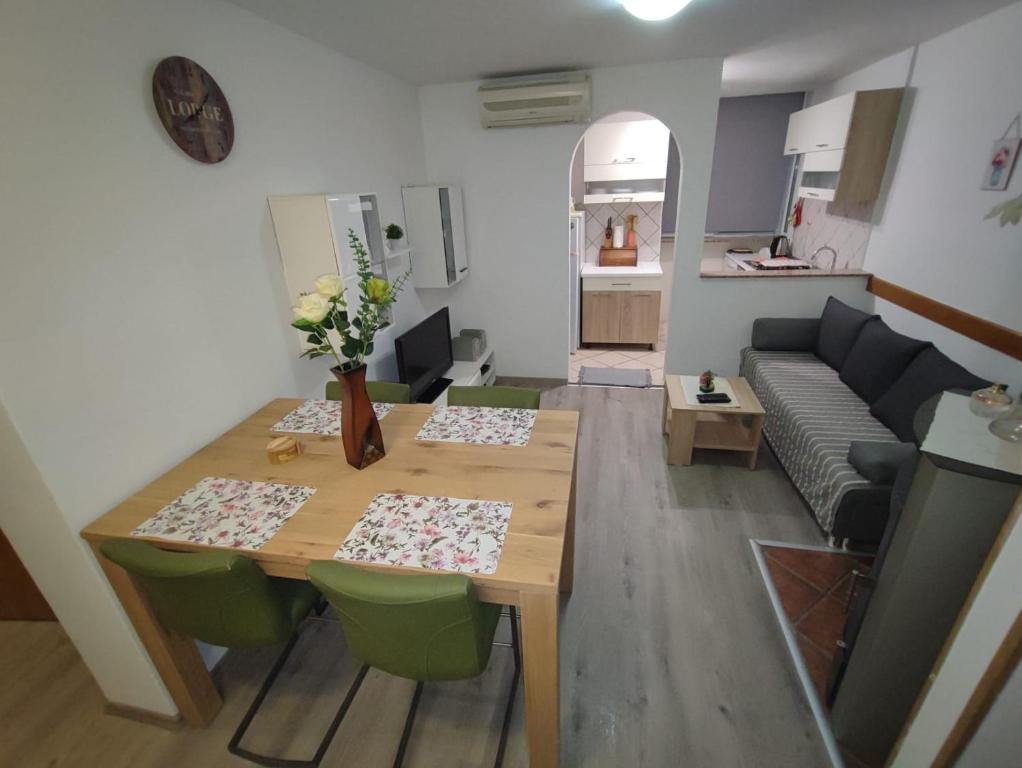 a living room with a table and a couch at Apartment Matea in Senj