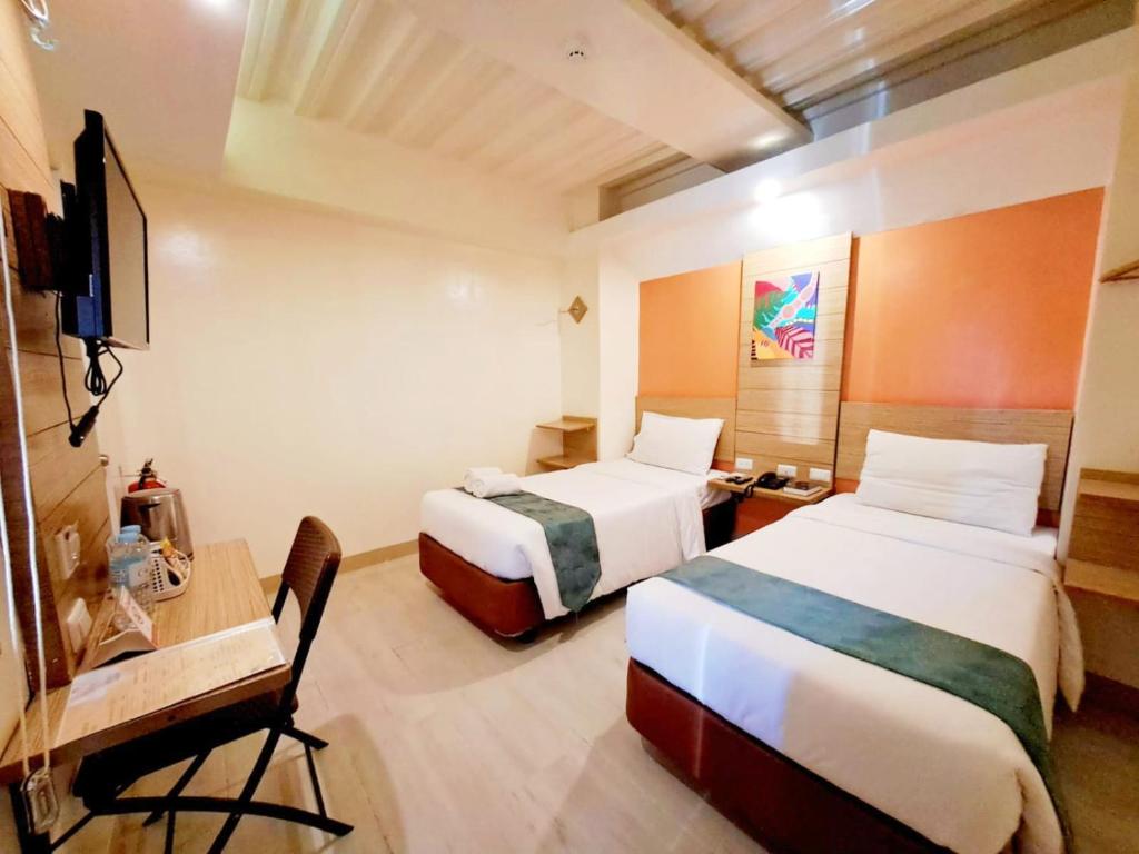 Postel nebo postele na pokoji v ubytování Chambre Hotel Mactan