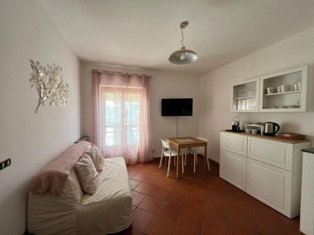 a living room with a couch and a table at La Perla Marina House in Chiavari