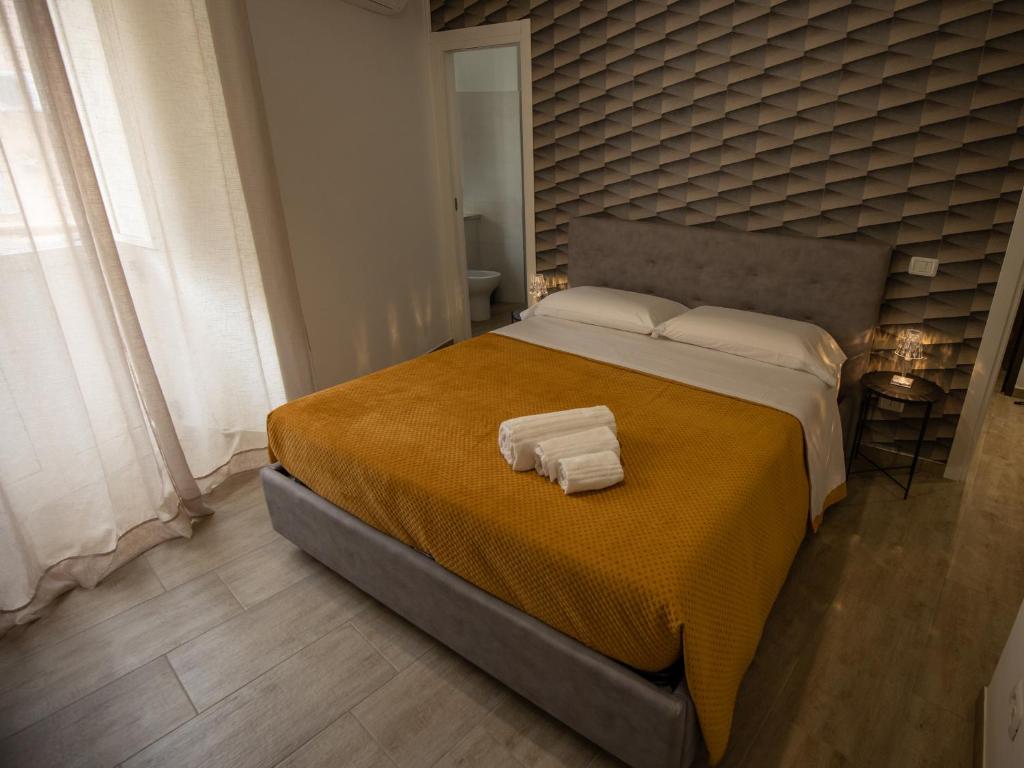 a bedroom with a large bed with two towels on it at Panta Rei in Lamezia Terme