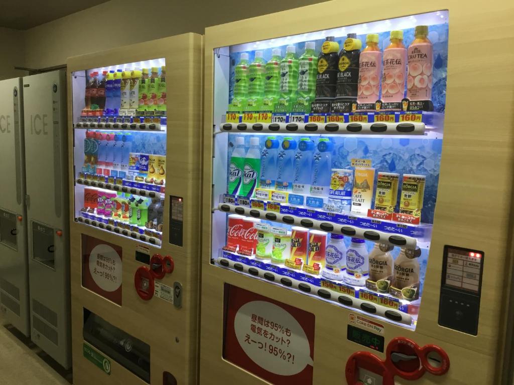 a vending machine filled with lots of bottles of soda at Odysis Suites Osaka Airport Hotel in Izumi-Sano