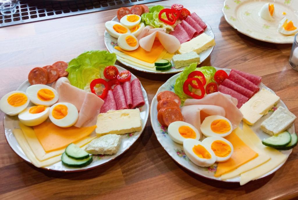 a table with four plates of different types of food at Pension Fanlor in Zubčická Lhotka