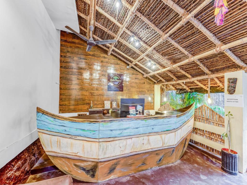 a large wooden boat in a room with a bar at Bella Vagues Beach Resort in Chennai