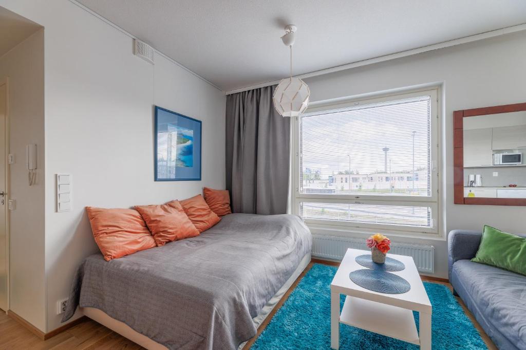 a living room with a bed and a couch at Close to center and Näsijärvi Lake - free parking, AC, and two double beds in Tampere
