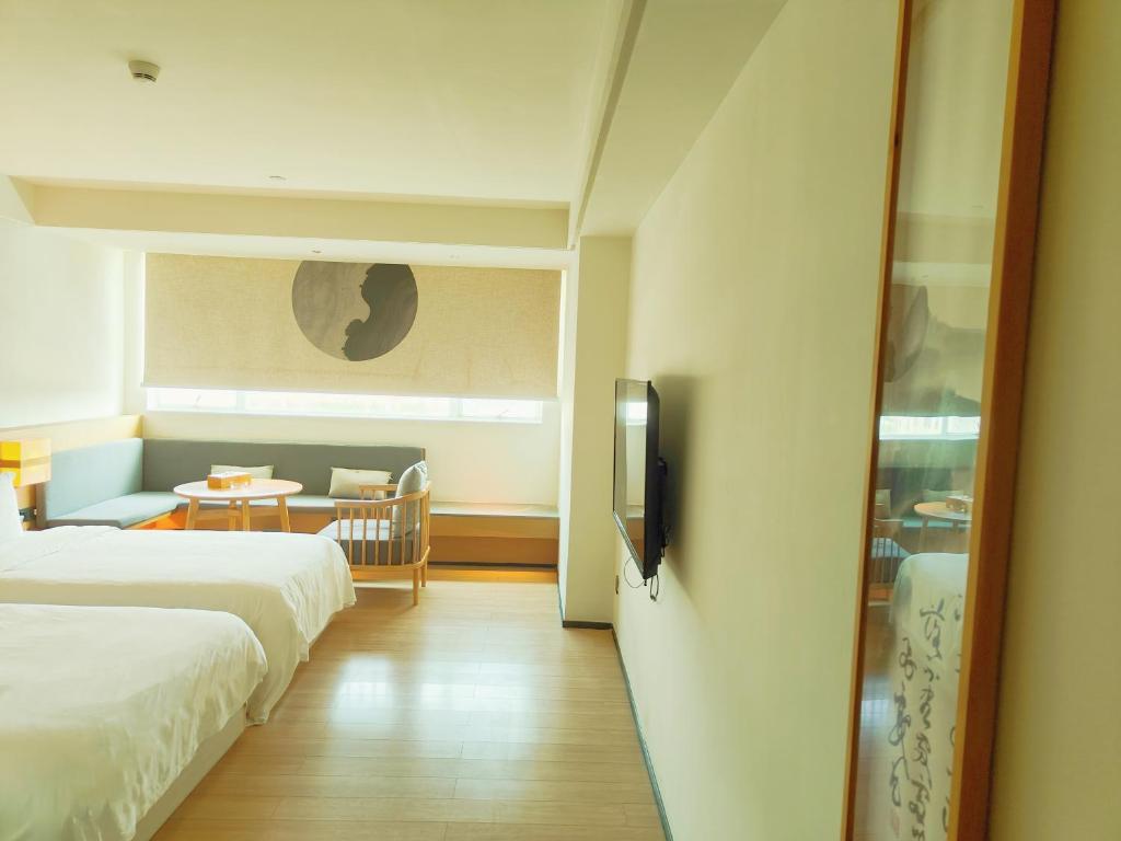 Postel nebo postele na pokoji v ubytování Guangzhou Shug Art Hotel