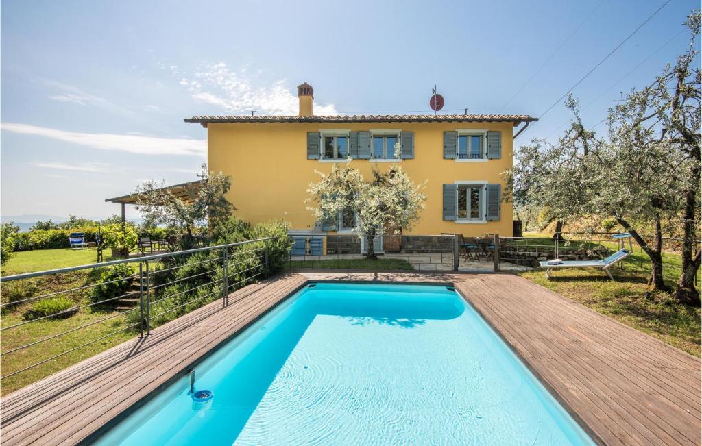 a villa with a swimming pool in front of a house at Casa Le Ginestre in Starda
