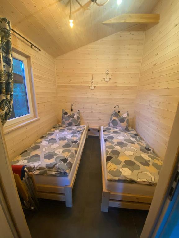 Krevet ili kreveti u jedinici u okviru objekta Domki Leśny Zakątek