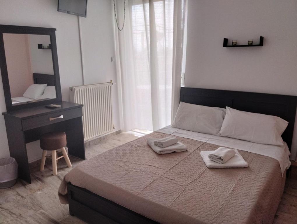 a bedroom with a bed with two towels on it at Katerina Apartments in Kalamata