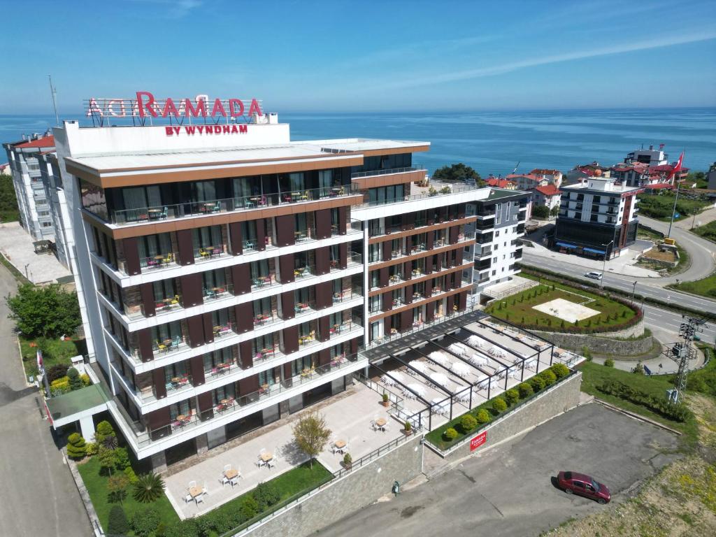 an aerial view of a building with the ocean in the background at Ramada By Wyndham Giresun Piraziz in Piraziz