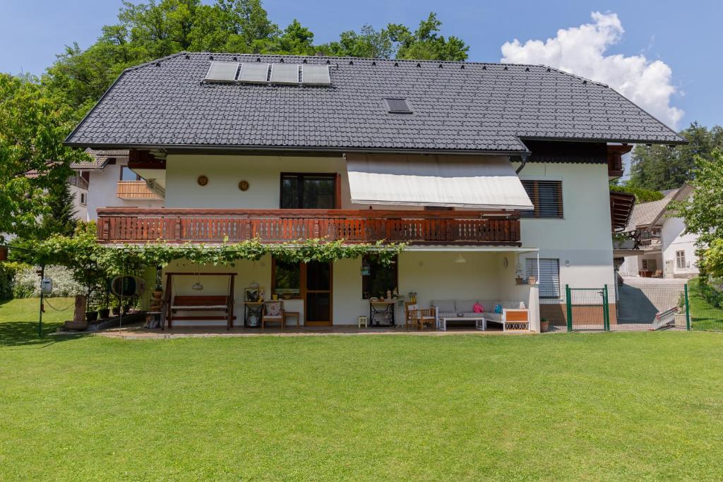 a house with a large lawn in front of it at Apartments Olip in Bled