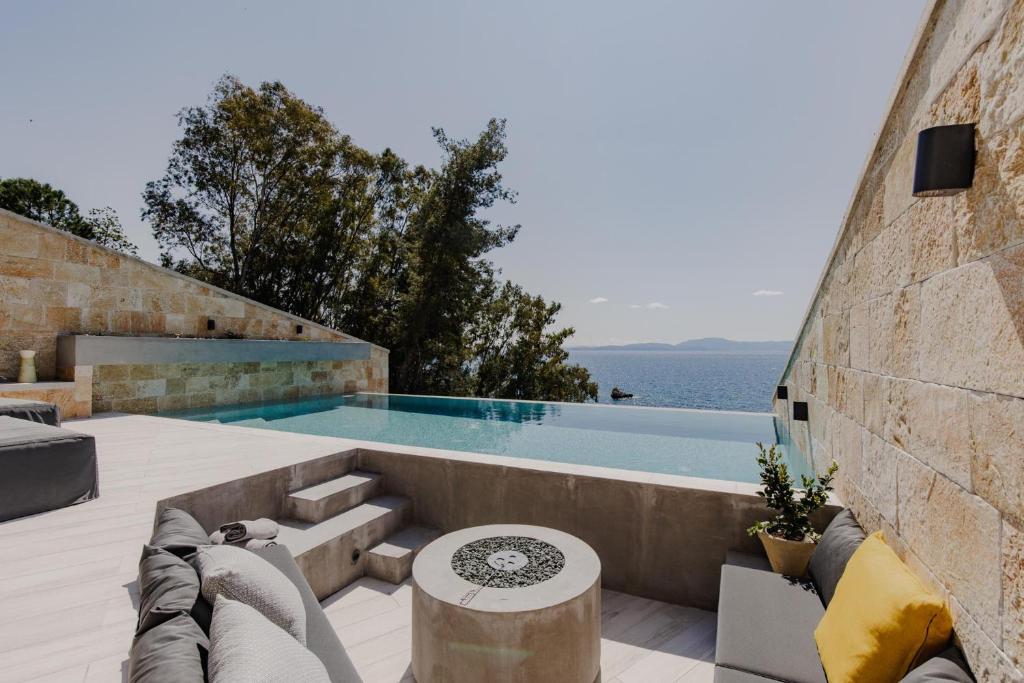a villa with a swimming pool and a patio at Villa Kastos in Paleros