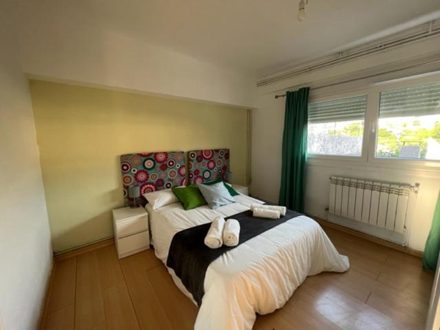 a bedroom with two beds and a large window at casa culleredo in A Coruña