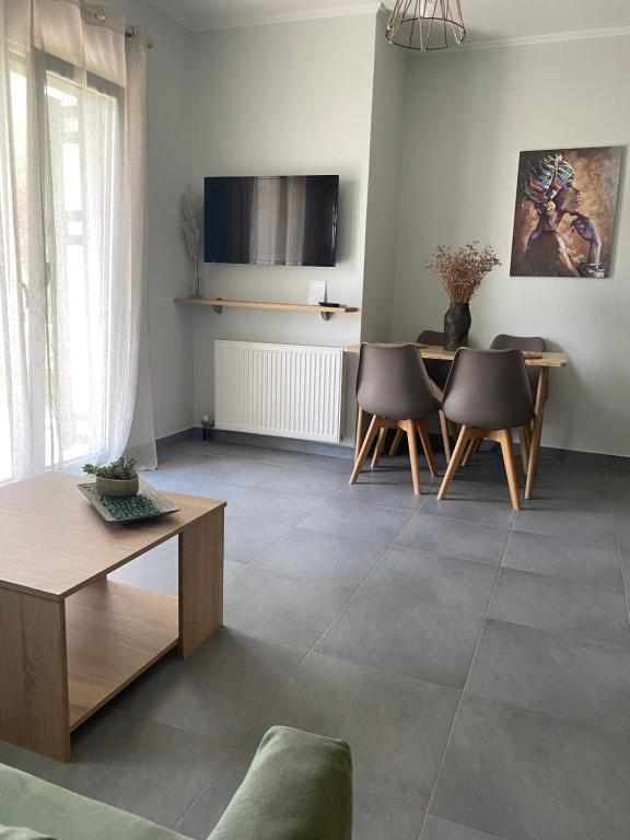 a living room with a table and chairs at Lefkada Town Apartment in Lefkada Town