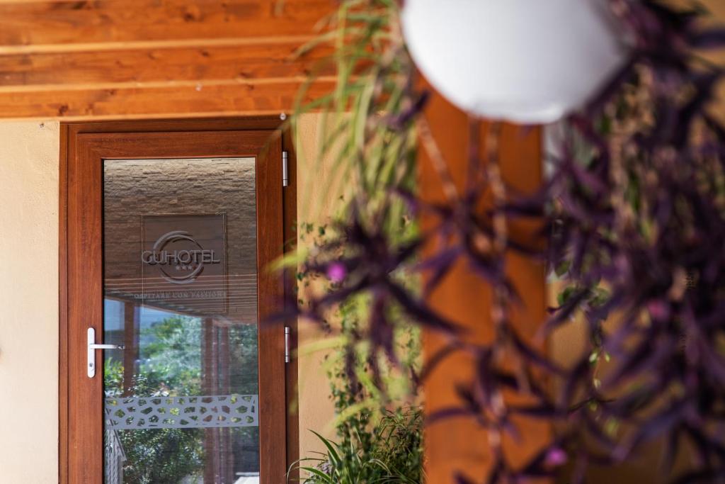 a close up of a door with a plant next to it at Gu Hotel in Guidonia