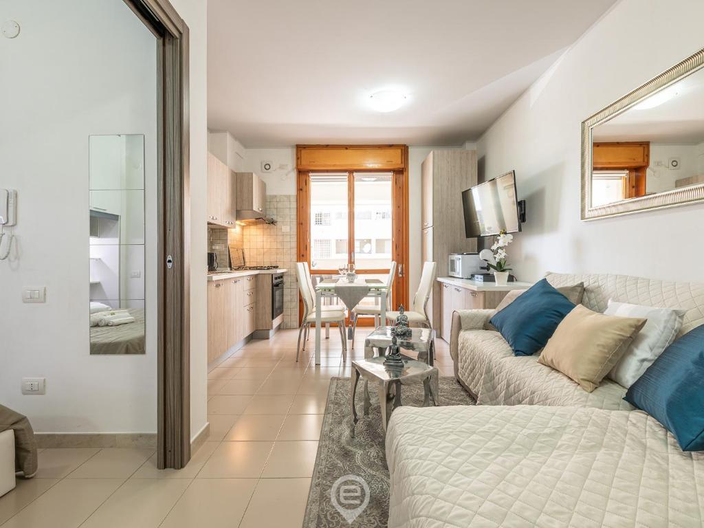 a living room with a couch and a table at Zaffiro Apartment in Quartu SantʼElena