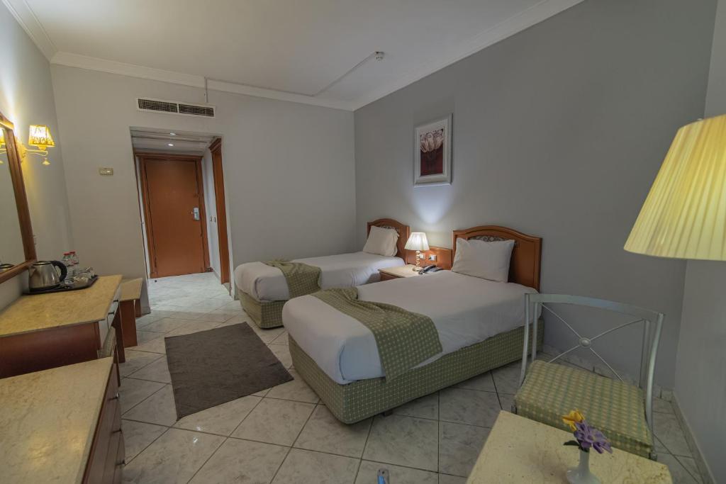 Postel nebo postele na pokoji v ubytování Dexon Roma Hotel