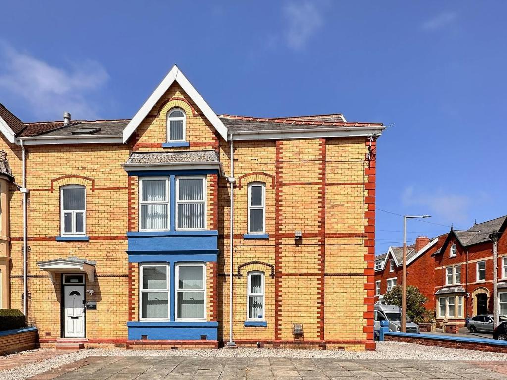 a brick building with a blue door on a street at Two - Uk43700 in Saint Annes on the Sea