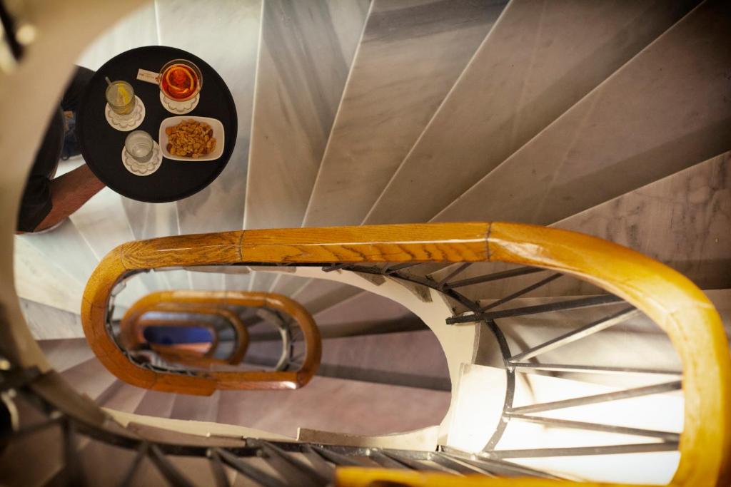 a spiral staircase with a table with food on it at Abc Hotel in Thessaloniki