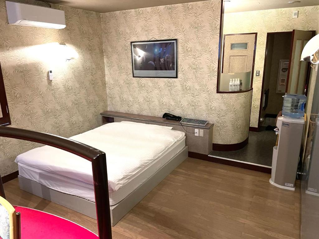 Postel nebo postele na pokoji v ubytování Hotel Ai - coupls hotel