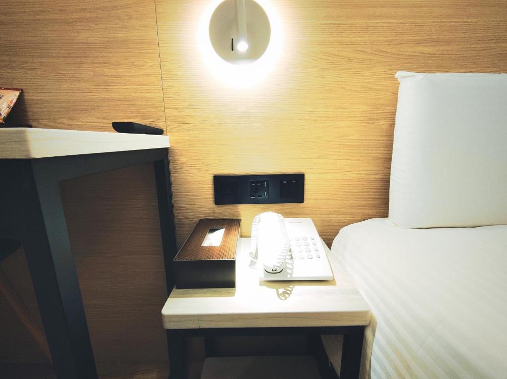 Postel nebo postele na pokoji v ubytování Hub Hotel Songshan Inn