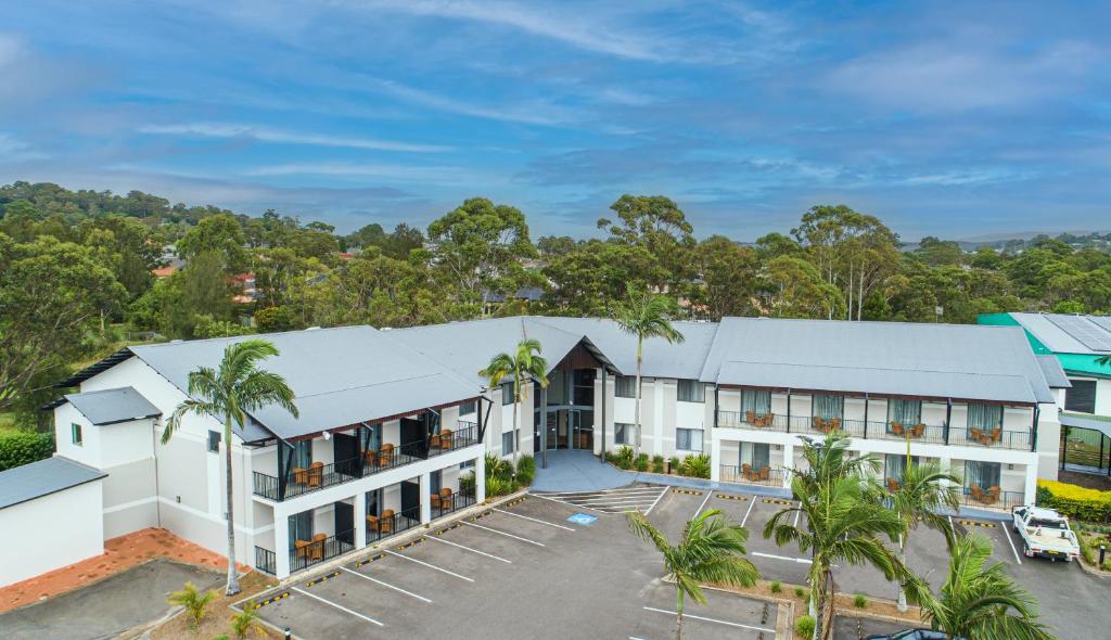 an aerial view of a hotel with palm trees at Warners at the Bay in Warners Bay