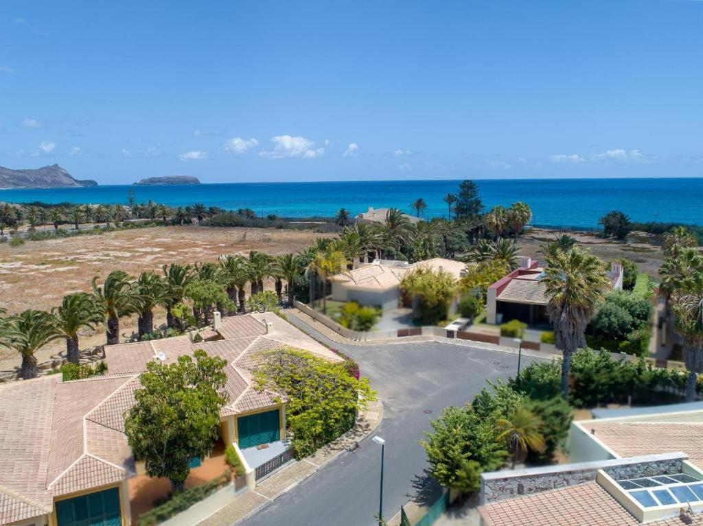 an aerial view of a resort with palm trees and the ocean at Oceano Azul in Porto Santo
