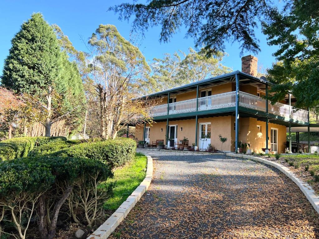 a house with a driveway in front of it at Entire Bowral Acreage in Bowral