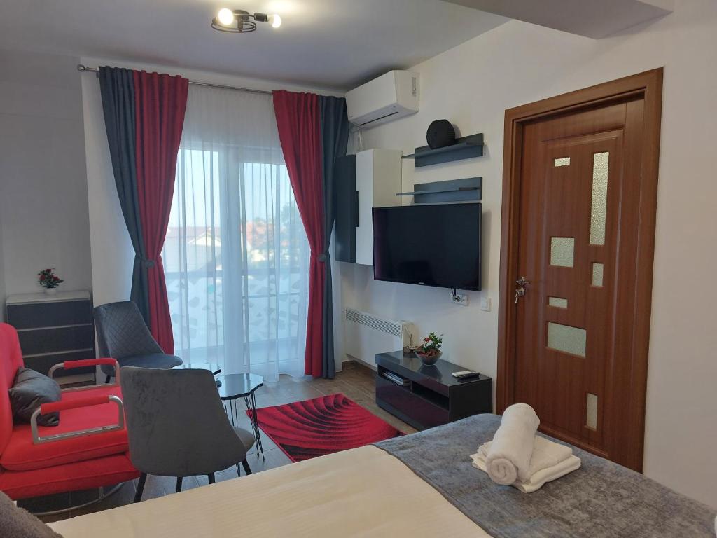 Habitación de hotel con cama y sala de estar. en Garsoniera Carmina, en Techirghiol