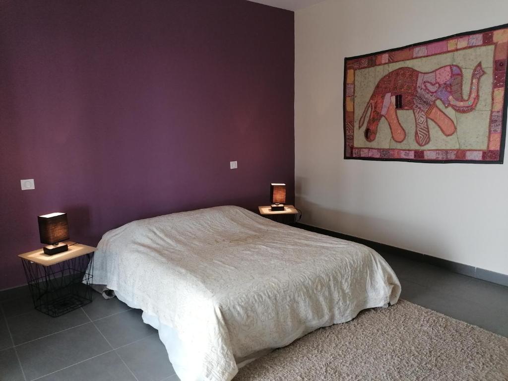 a bedroom with a bed and two tables with lamps at CHAMBRE AVENTURE VUE EXCEPTIONNELLE PORTICCIO in Porticcio