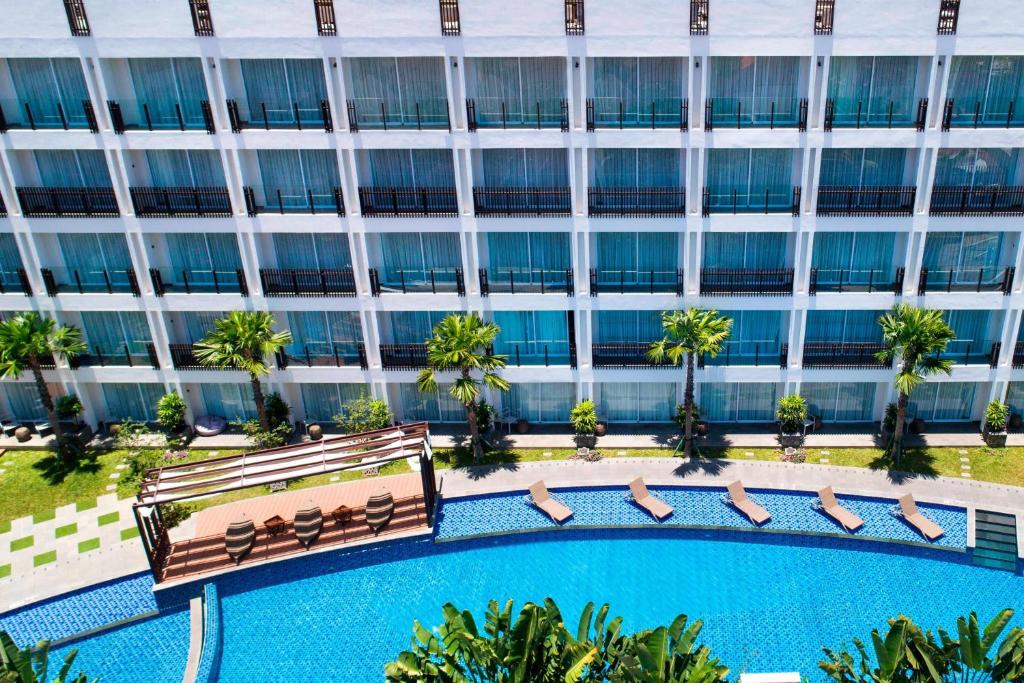 an overhead view of a hotel with a pool and a building at Fairfield by Marriott Bali Legian in Legian