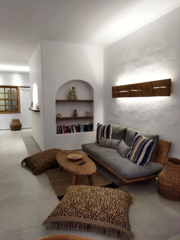 a living room with a couch and a table at Hotel Flisvos in Megalochori