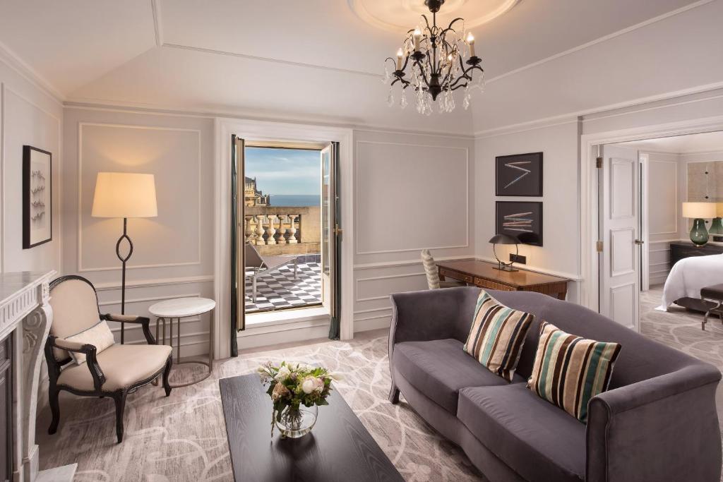 a living room with a couch and a bed at Hotel Maria Cristina, a Luxury Collection Hotel, San Sebastian in Donostia-San Sebastián
