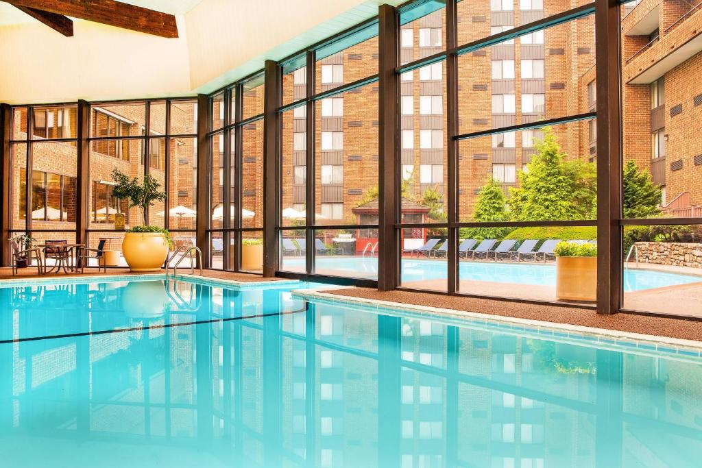an indoor swimming pool with a large window at Sheraton Harrisburg Hershey Hotel in Harrisburg