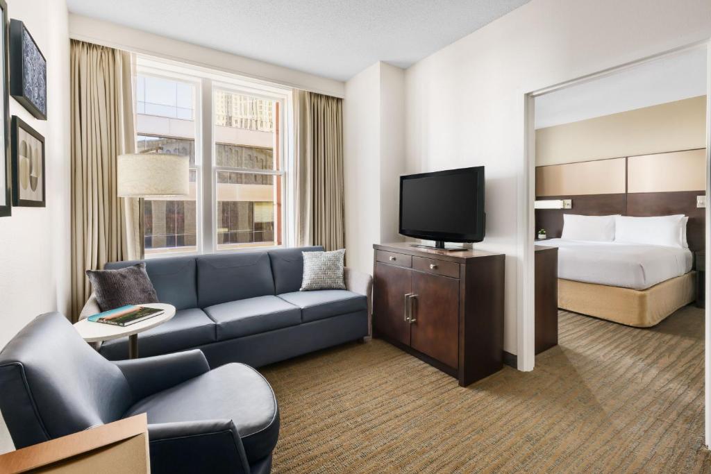 a hotel room with a couch and a bed at Residence Inn Atlanta Downtown in Atlanta