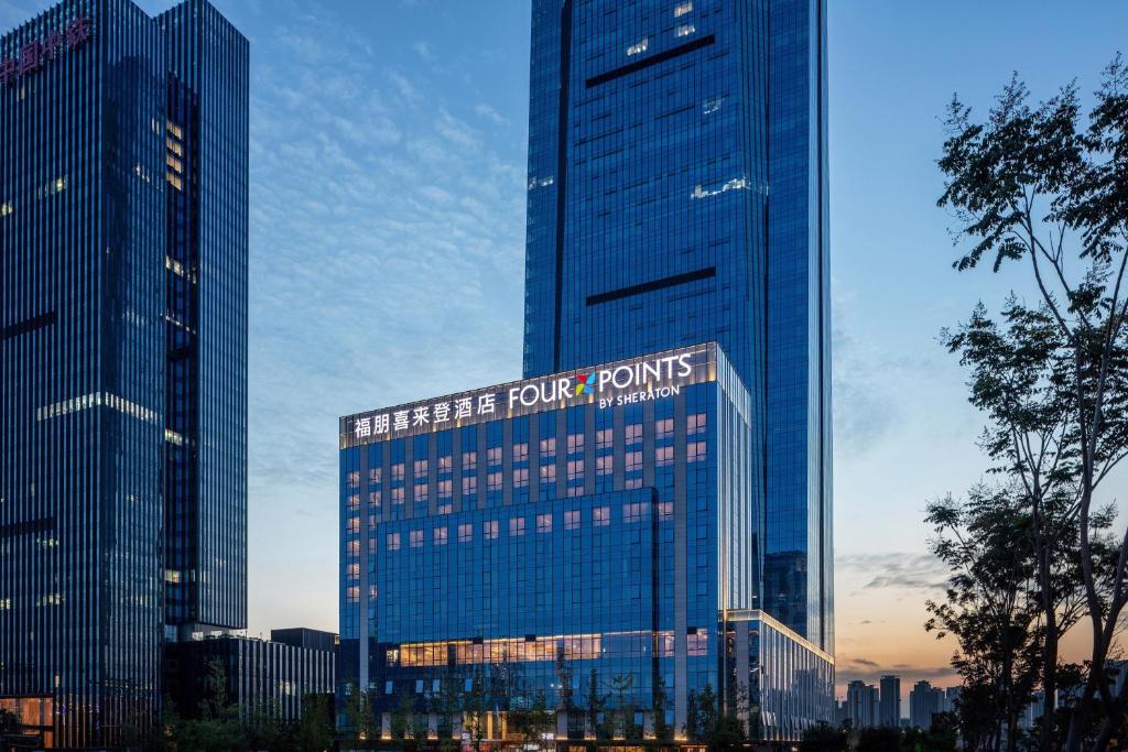 wysoki budynek z znakiem na górze w obiekcie Four Points by Sheraton Chengdu Tianfu New Area w mieście Chengdu